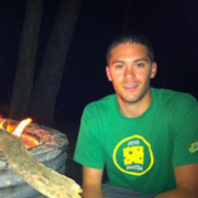 Patric Vaelli sitting next to a bonfire